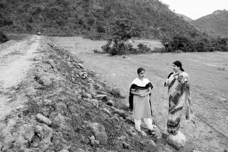 Jaya Devi - the Water Lady - explaining to Nandita Singh, a scientist from Stockholm, Sweden about the checkdam being constructed across Kareli Nala through community participation